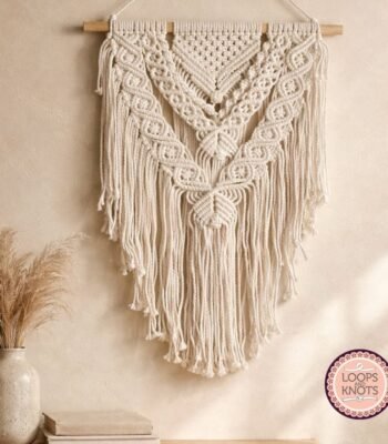 Handmade boho macramé wall hanging with intricate geometric knots and flowing fringe