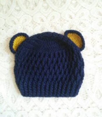 Handmade navy blue crochet baby bear ear cap with yellow inner ear detailing