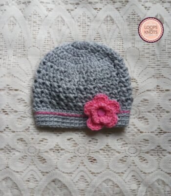 Handmade grey crochet baby beanie cap with pink flower appliqué and contrast stripe