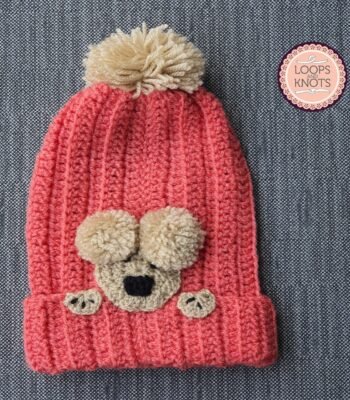 Handmade pink crochet baby bear pom pom beanie cap with cute bear face appliqué